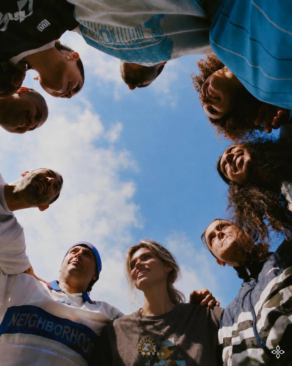 People gathered in a circle under an open sky